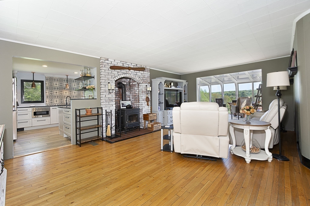 27 Old Poor Farm Road Ware, MA 01082 - Photo 6 of 42 a living room with furniture and a large window with kitchen view
