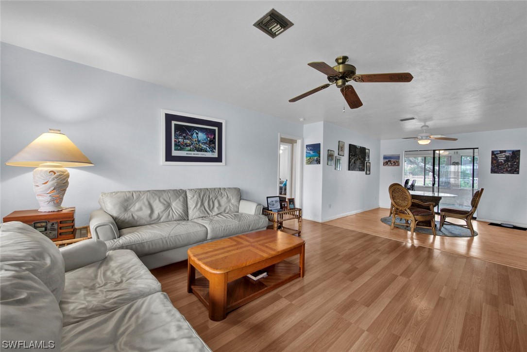 7234 Myrtle Road Fort Myers, FL 33967 - Photo 1 of 32 a living room with furniture and a wooden floor