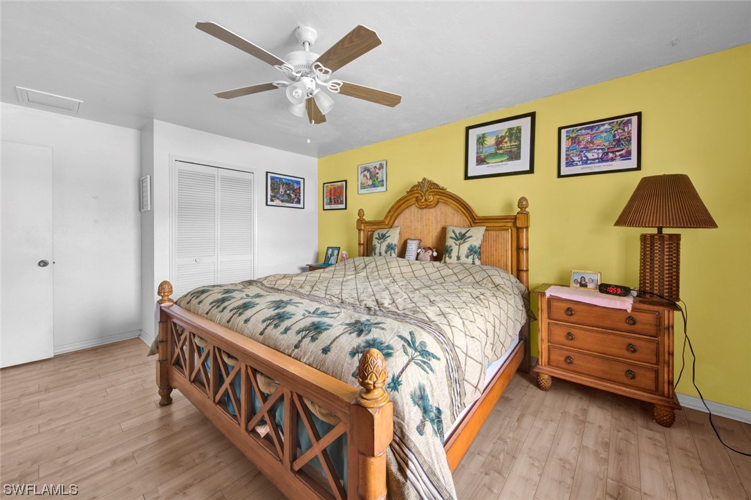 7234 Myrtle Road Fort Myers, FL 33967 - Photo 13 of 32 a bedroom with a bed and a chandelier