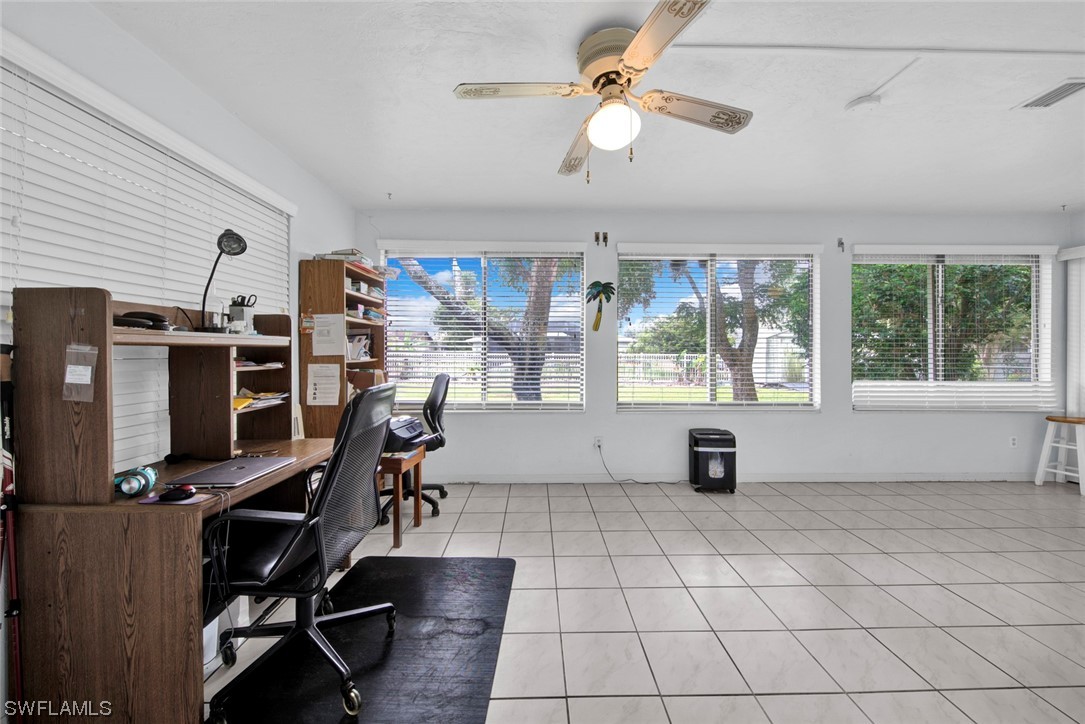 7234 Myrtle Road Fort Myers, FL 33967 - Photo 19 of 32 a view of a workspace with furniture and a window