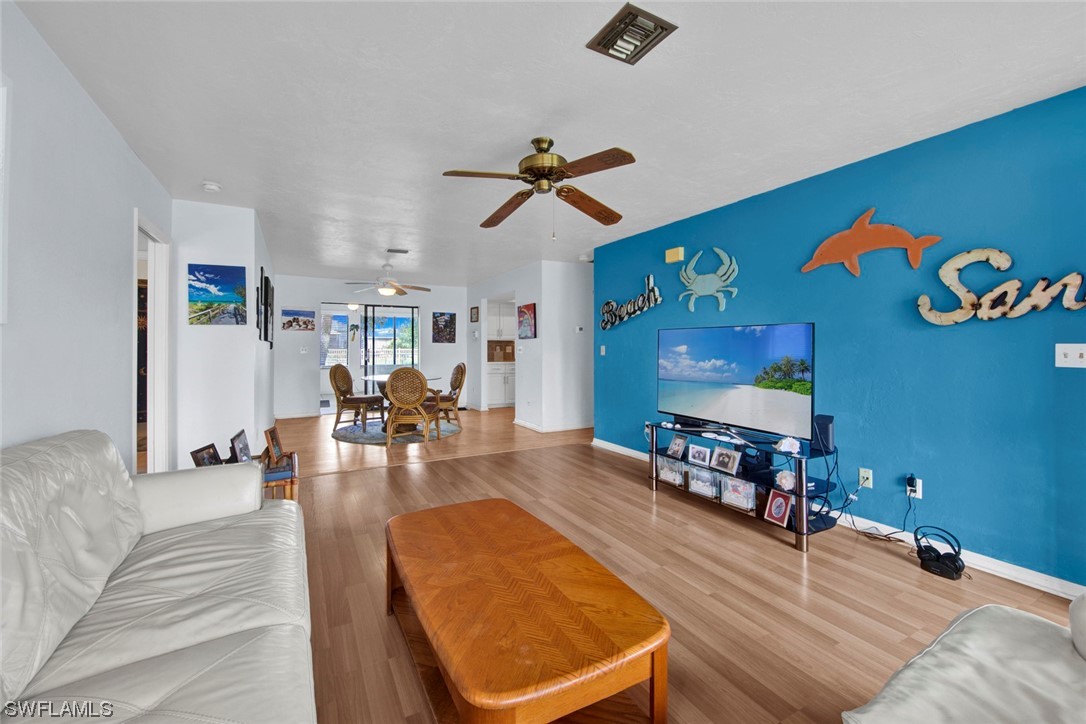 7234 Myrtle Road Fort Myers, FL 33967 - Photo 2 of 32 a living room with furniture and wooden floor