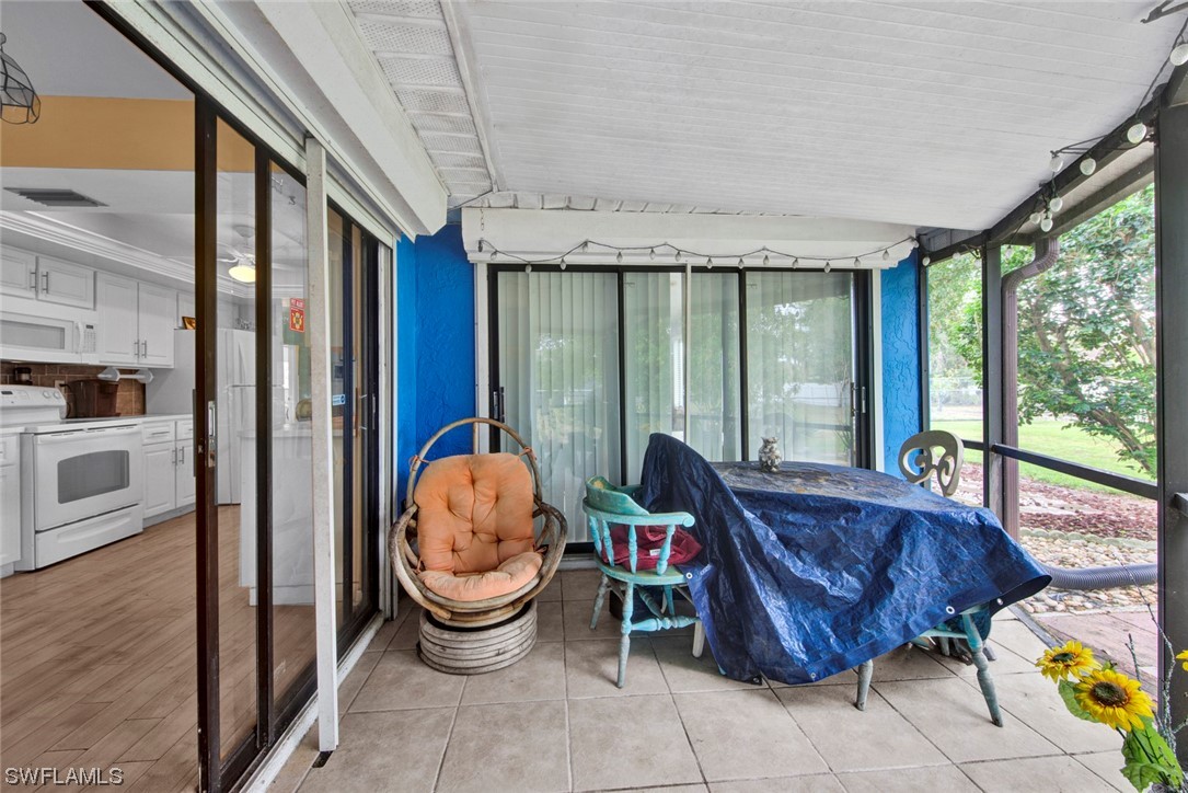 7234 Myrtle Road Fort Myers, FL 33967 - Photo 23 of 32 a living room with furniture and a floor to ceiling window