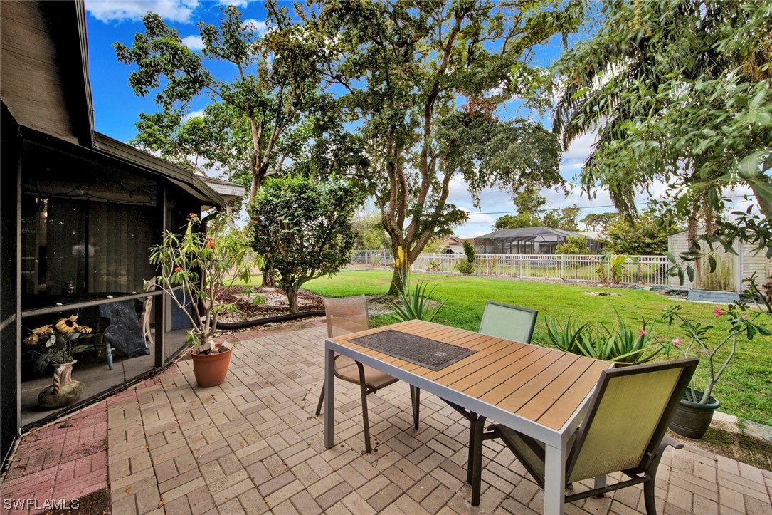 7234 Myrtle Road Fort Myers, FL 33967 - Photo 24 of 32 a view of a patio with table and chairs potted plants and large tree