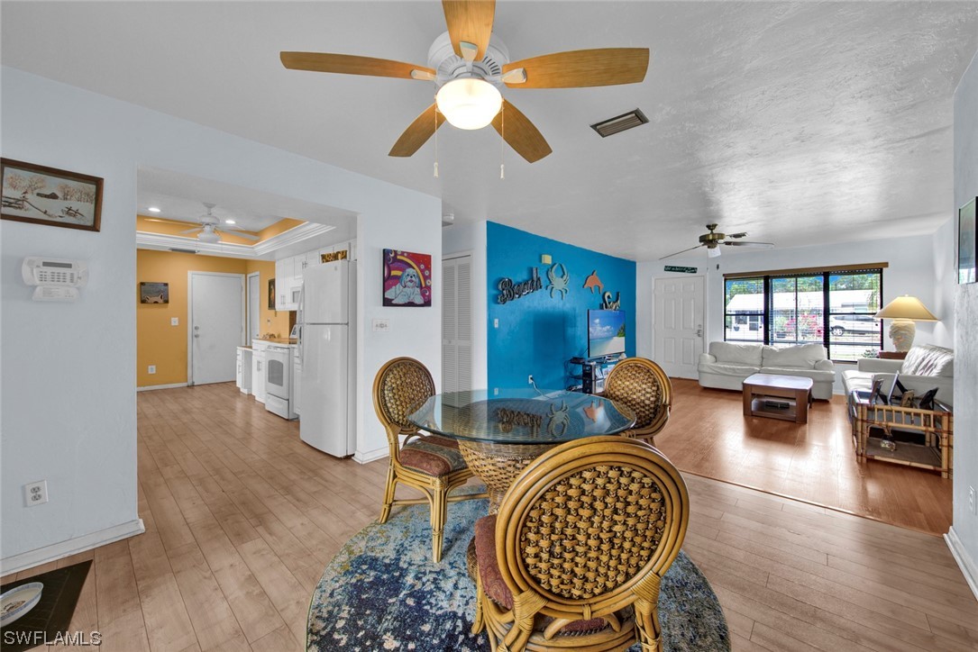 7234 Myrtle Road Fort Myers, FL 33967 - Photo 5 of 32 a living room with furniture a chandelier fan and a rug