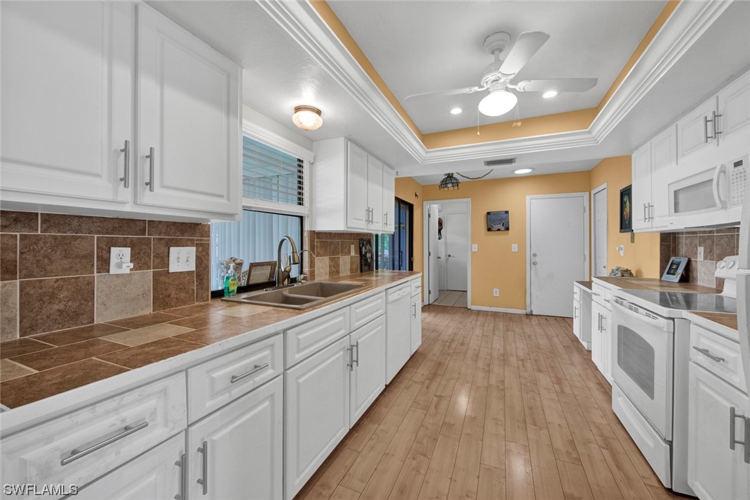 7234 Myrtle Road Fort Myers, FL 33967 - Photo 8 of 32 a large kitchen with stainless steel appliances granite countertop a lot of counter space and wooden floors