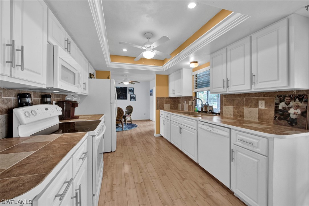 7234 Myrtle Road Fort Myers, FL 33967 - Photo 10 of 32 a kitchen with stainless steel appliances granite countertop a lot of counter space sink and cabinets