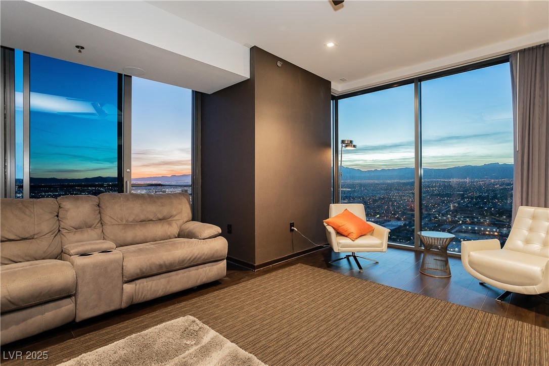 4381 West Flamingo Road, Unit 53321 Las Vegas, NV 89103 - Photo 17 of 41 Living area featuring floor to ceiling windows, wood finished floors, and a mountain view