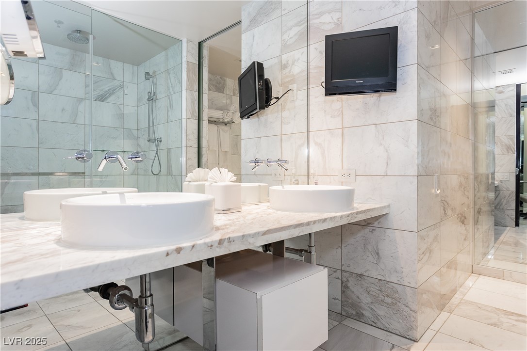 4381 West Flamingo Road, Unit 53321 Las Vegas, NV 89103 - Photo 27 of 41 Full bath featuring tile walls and a shower stall