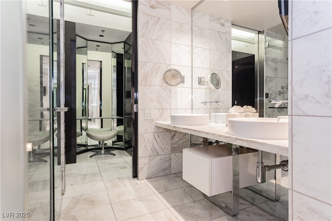 4381 West Flamingo Road, Unit 53321 Las Vegas, NV 89103 - Photo 30 of 41 Full bathroom featuring tile walls, double sink, and elevator