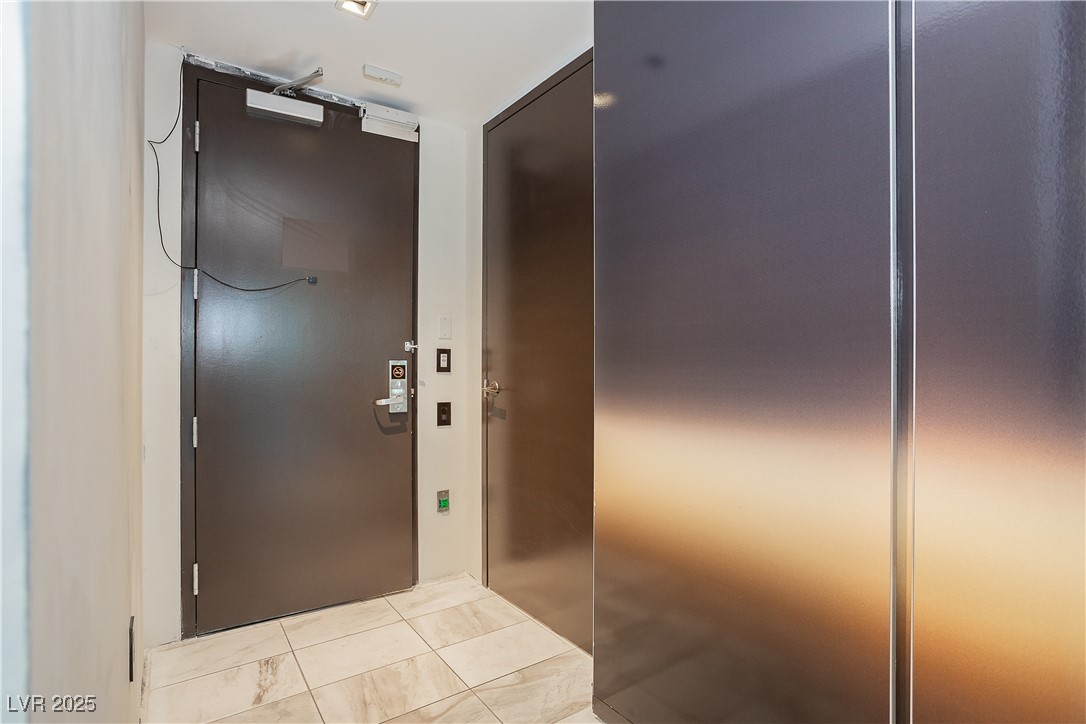 4381 West Flamingo Road, Unit 53321 Las Vegas, NV 89103 - Photo 3 of 41 Doorway featuring tile patterned flooring