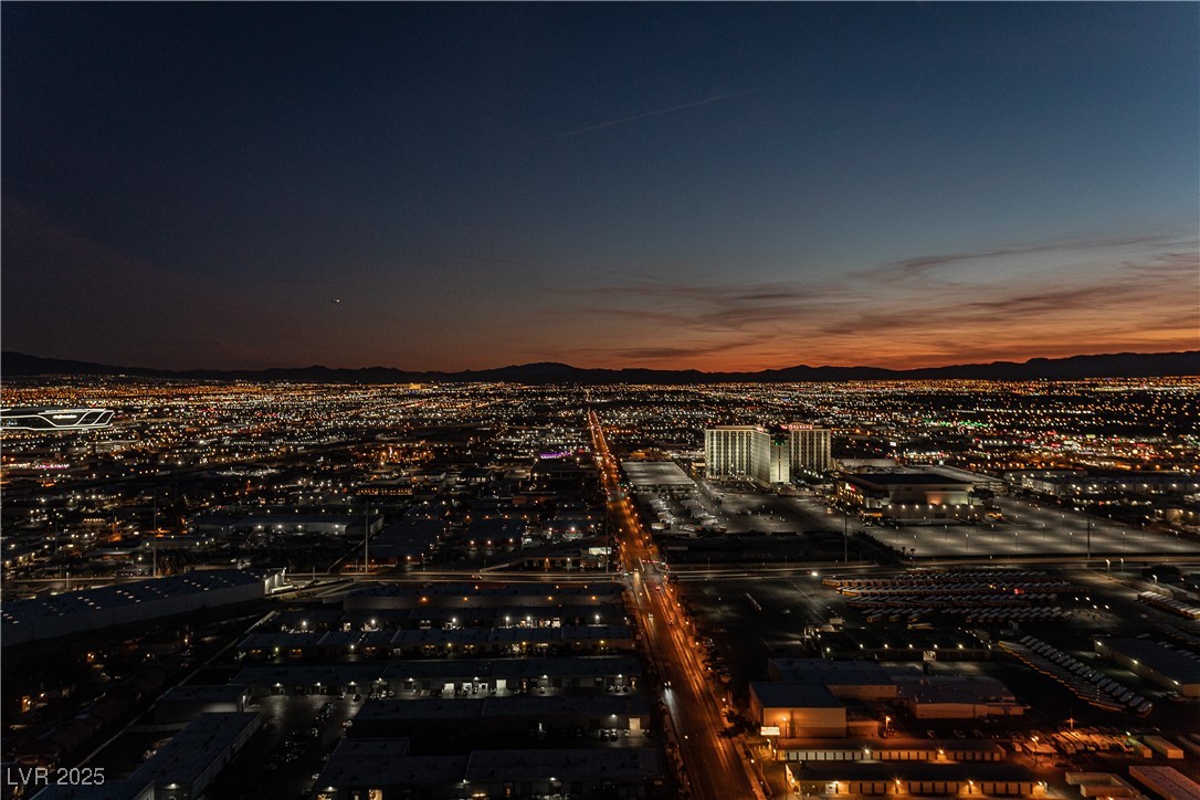 4381 West Flamingo Road, Unit 53321 Las Vegas, NV 89103 - Photo 34 of 41 Aerial view of property and surrounding area featuring nearby urban area and a mountainous background