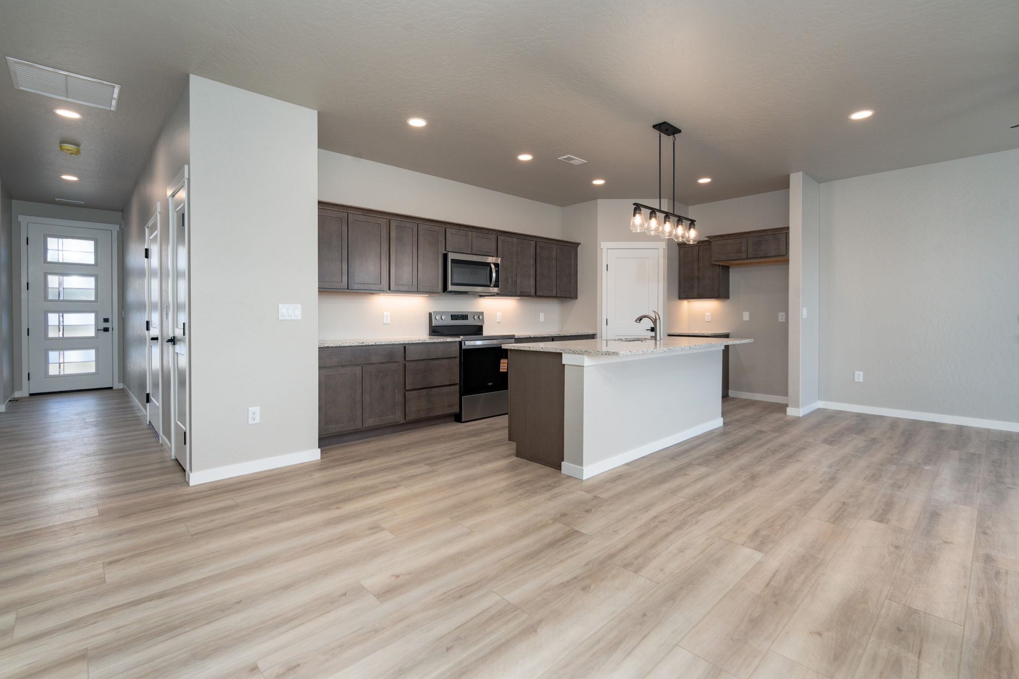 1750 Caliper Way Fruita, CO 81521 - Photo 15 of 19 a view of kitchen with wooden floor and electronic appliances
