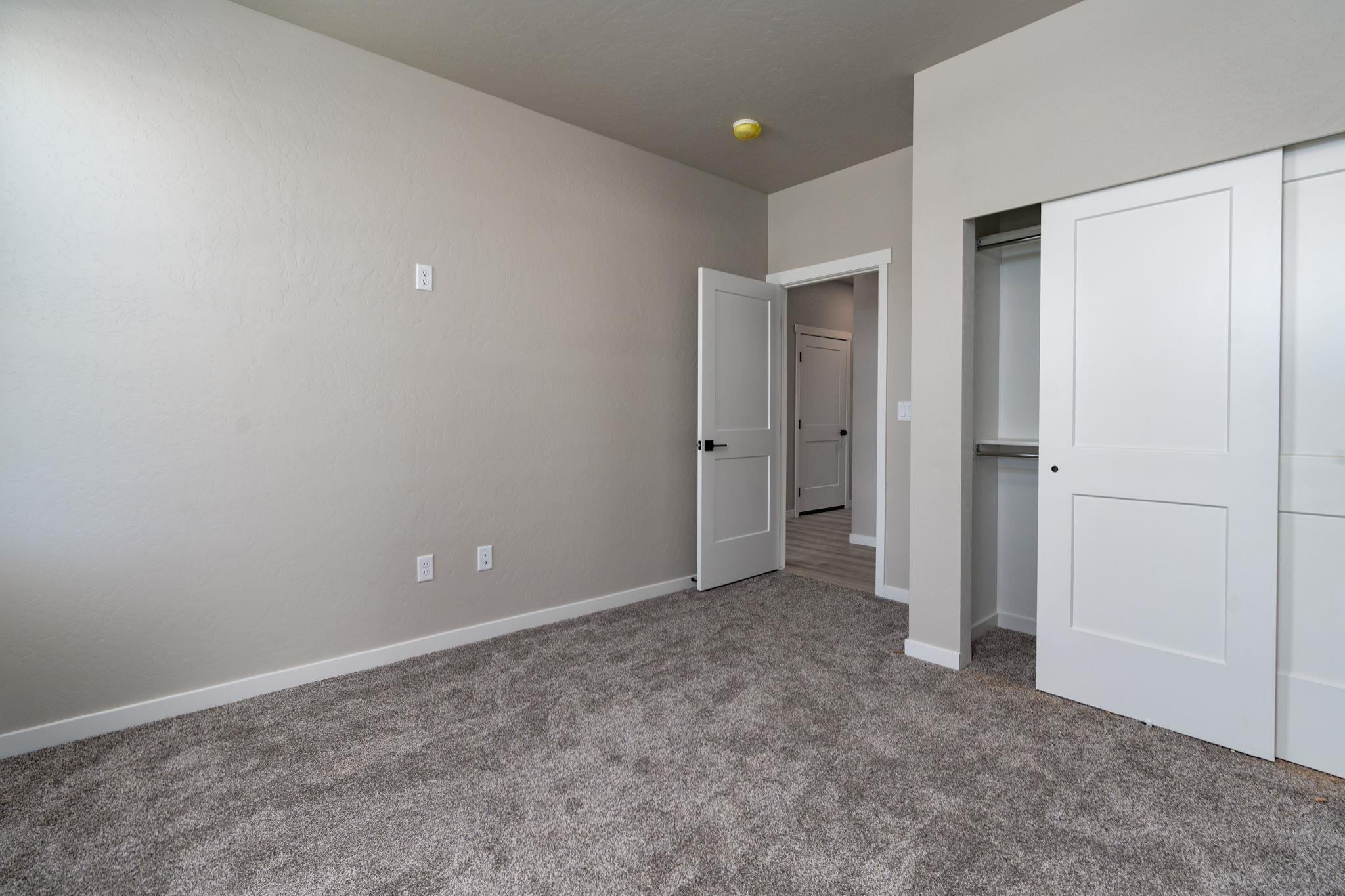 1750 Caliper Way Fruita, CO 81521 - Photo 5 of 19 an empty room with closet and a bathroom