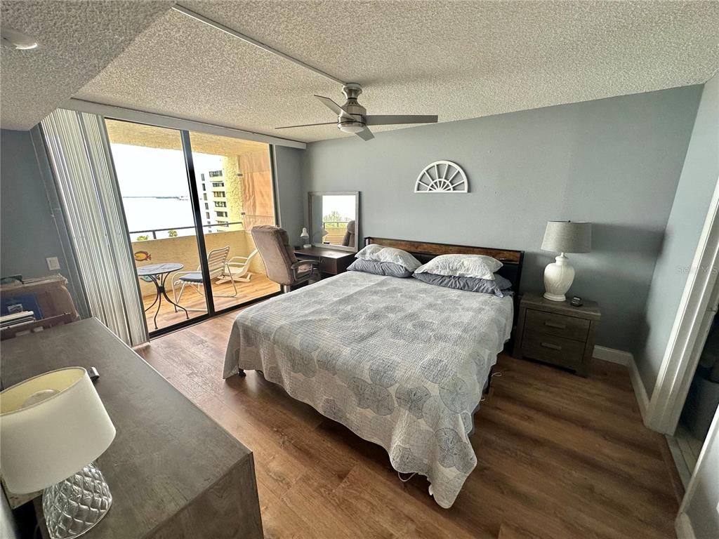 6009 Sea Ranch Drive, Unit 704 Hudson, FL 34667 - Photo 12 of 57 a bedroom with a bed and wooden floor