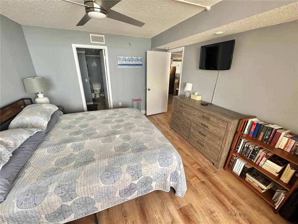 6009 Sea Ranch Drive, Unit 704 Hudson, FL 34667 - Photo 13 of 57 a bedroom with a bed and flat screen tv