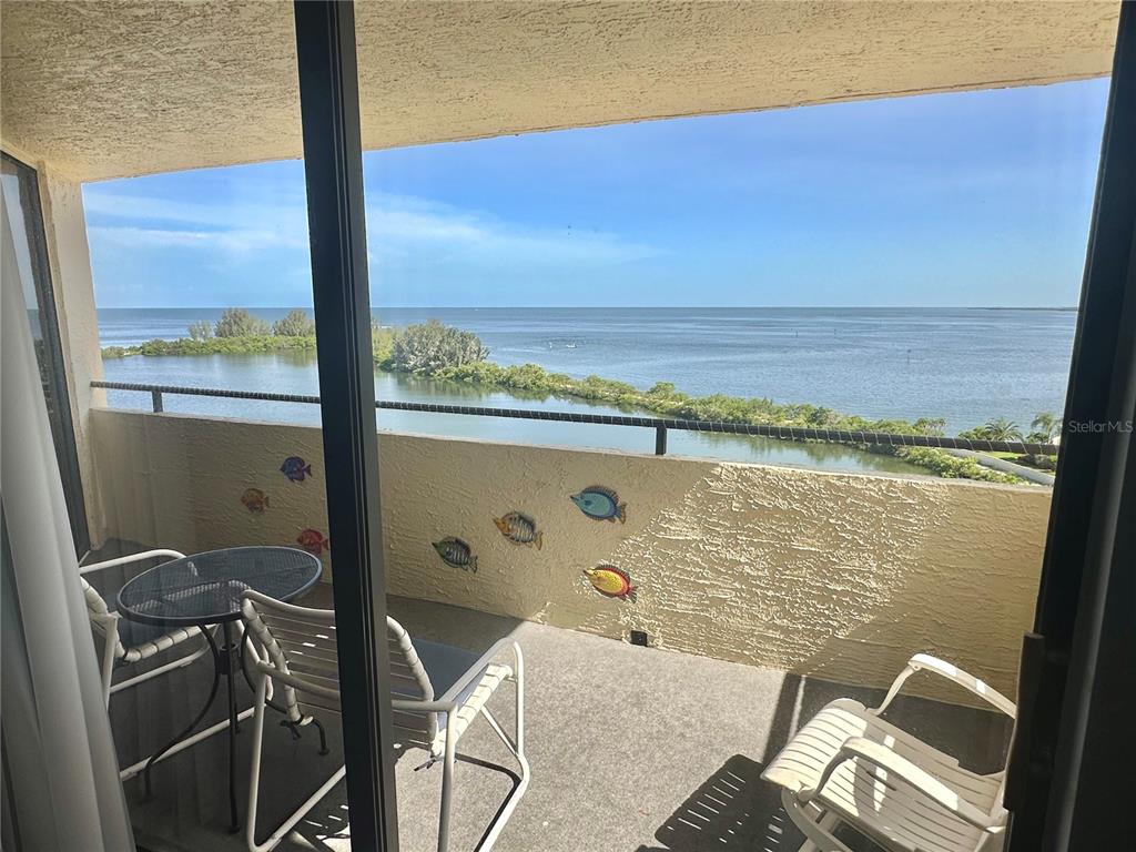 6009 Sea Ranch Drive, Unit 704 Hudson, FL 34667 - Photo 14 of 57 a view of a balcony with chair and table
