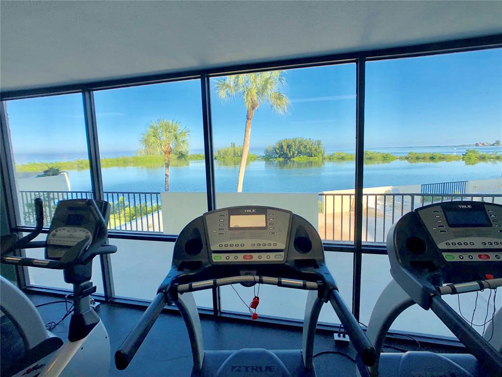 6009 Sea Ranch Drive, Unit 704 Hudson, FL 34667 - Photo 46 of 57 a view of a city from a dining room with large windows