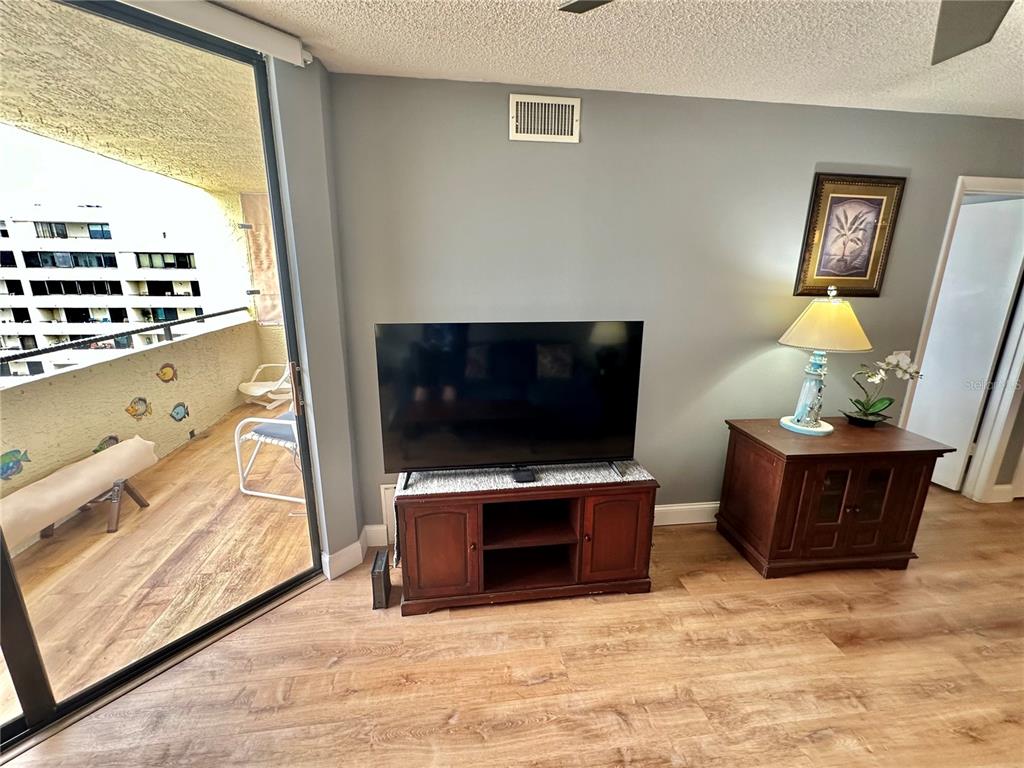 6009 Sea Ranch Drive, Unit 704 Hudson, FL 34667 - Photo 9 of 57 a living room with furniture and a flat screen tv