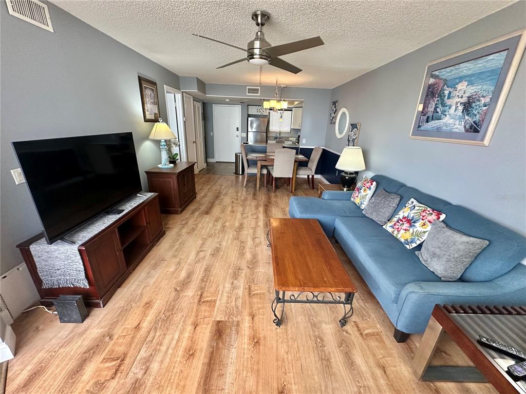 6009 Sea Ranch Drive, Unit 704 Hudson, FL 34667 - Photo 10 of 57 a living room with furniture and a flat screen tv
