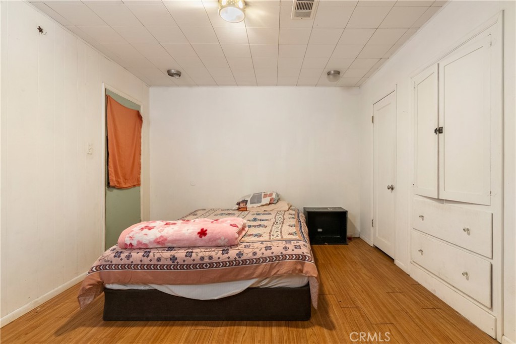 170 Pacific Avenue Paso Robles, CA 93446 - Photo 17 of 34 a bedroom with a bed and wooden floor