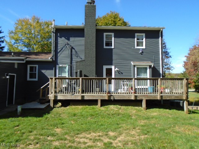 10971 Auburn Road Chardon, OH 44024 - Photo 40 of 40 Rear view of house featuring a deck, a lawn, and a chimney