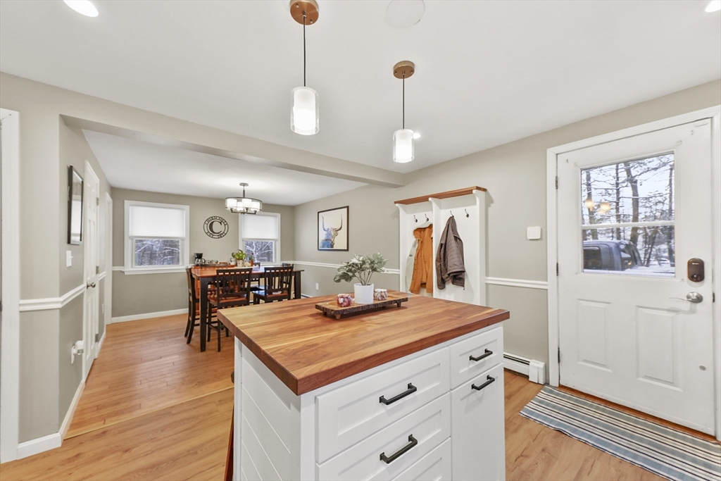 135 Conant Road Nashua, NH 03062 - Photo 13 of 40 a view of a kitchen area kitchen island dining table and wooden floor