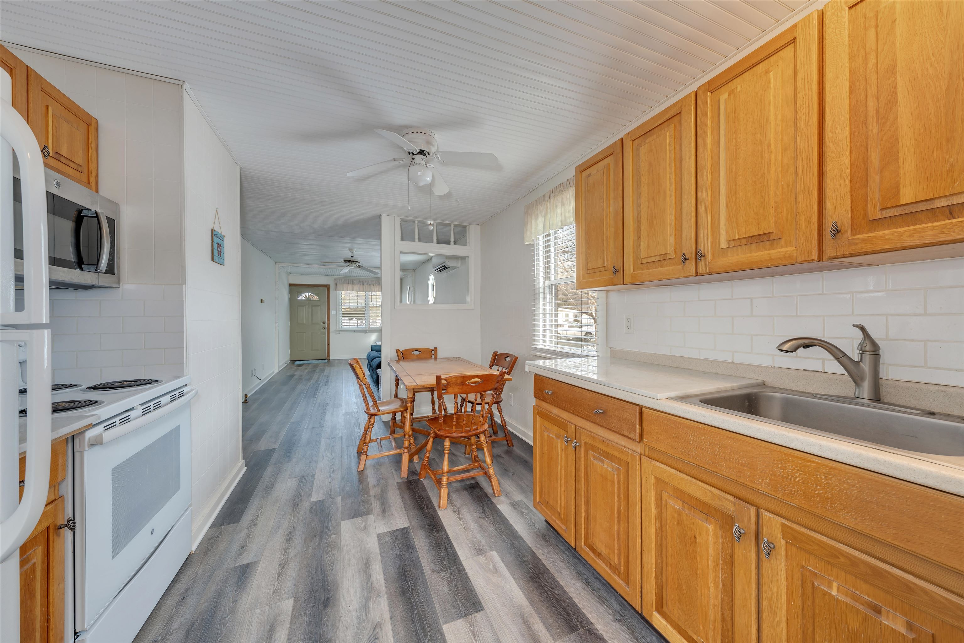 48 Spruce Avenue Villas, NJ 08251 - Photo 8 of 37 a kitchen with stainless steel appliances granite countertop a sink a stove cabinets dining table and chairs