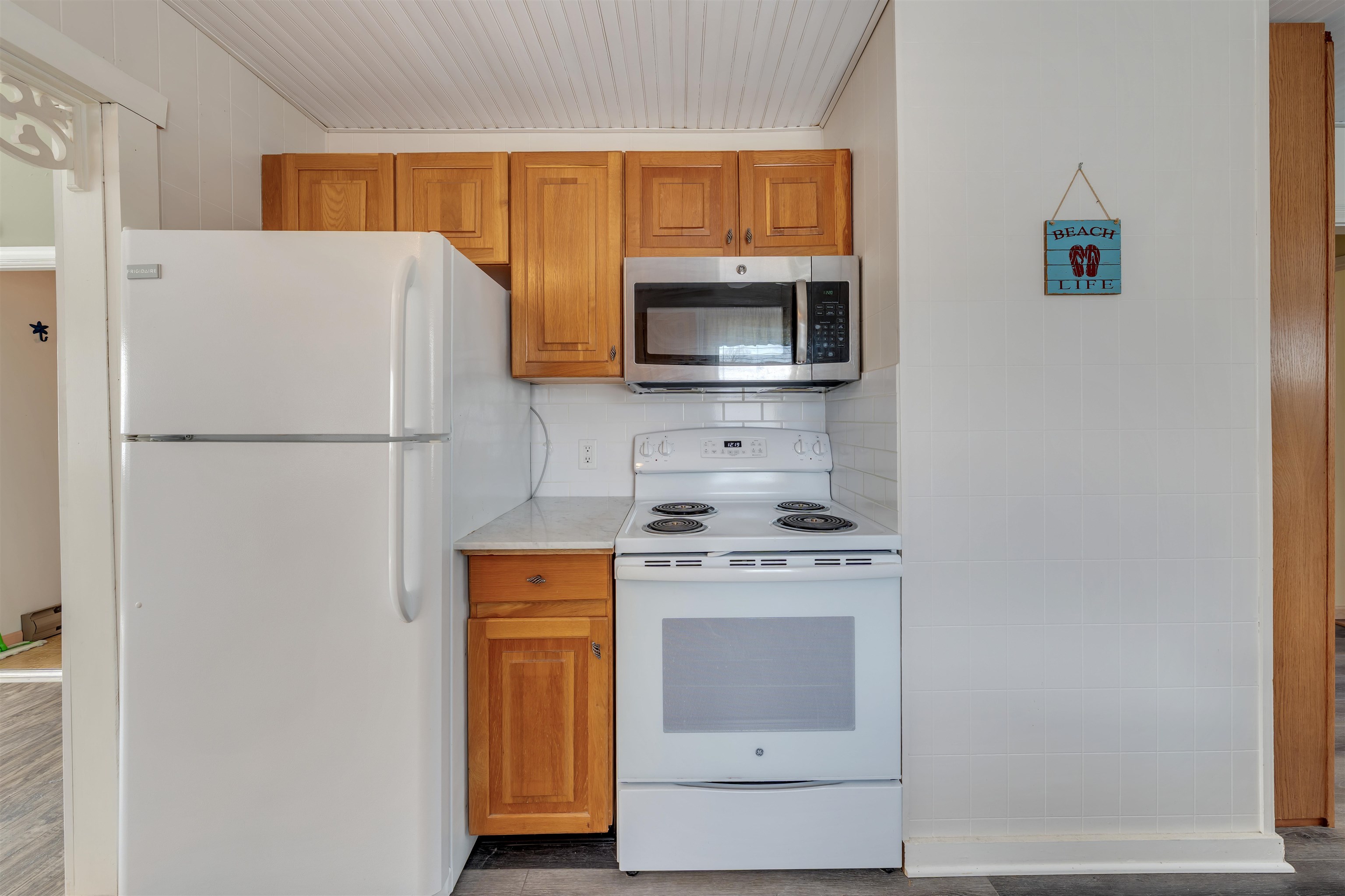 48 Spruce Avenue Villas, NJ 08251 - Photo 9 of 37 a kitchen with a refrigerator a stove top oven a washer and dryer