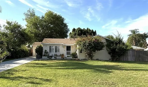a front view of a house with a yard table and chairs
