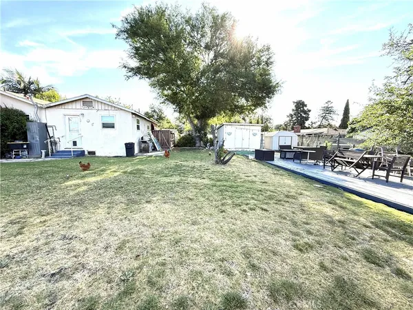 a view of a house with a yard and sitting area