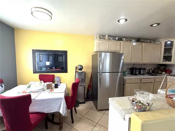 a kitchen with stainless steel appliances granite countertop a dining table and chairs