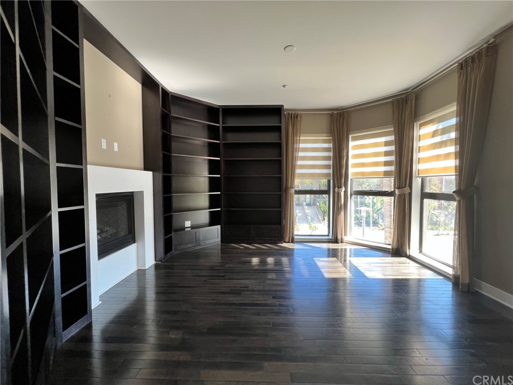 402 Rockefeller, Unit 212 Irvine, CA 92612 - Photo 11 of 27 a room with wooden floor and windows