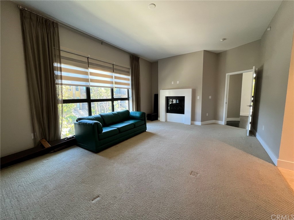 402 Rockefeller, Unit 212 Irvine, CA 92612 - Photo 13 of 27 a living room with furniture and a fireplace