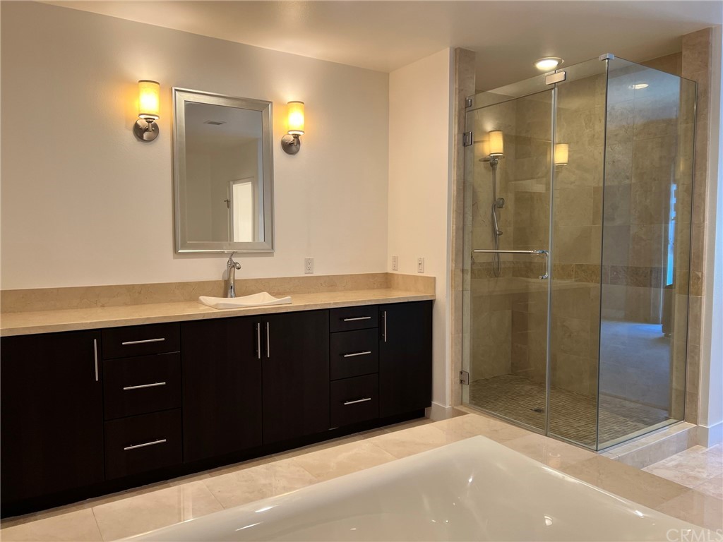 402 Rockefeller, Unit 212 Irvine, CA 92612 - Photo 15 of 27 a bathroom with a sink vanity and shower