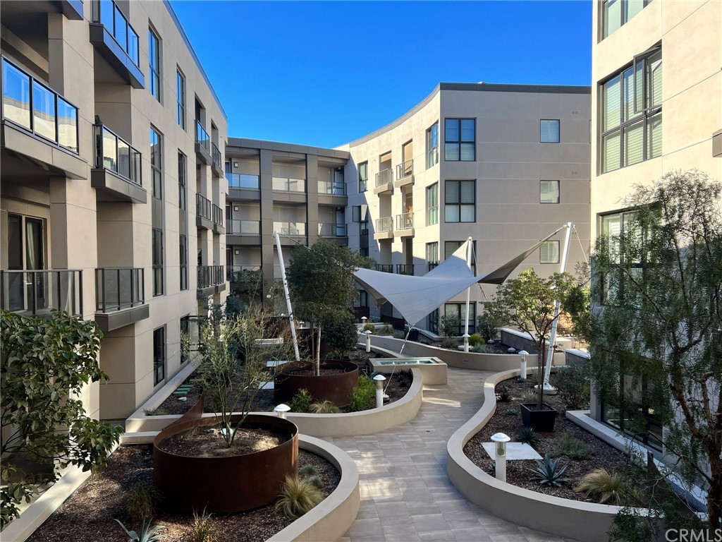 402 Rockefeller, Unit 212 Irvine, CA 92612 - Photo 20 of 27 a view of a patio with table and chairs and potted plants