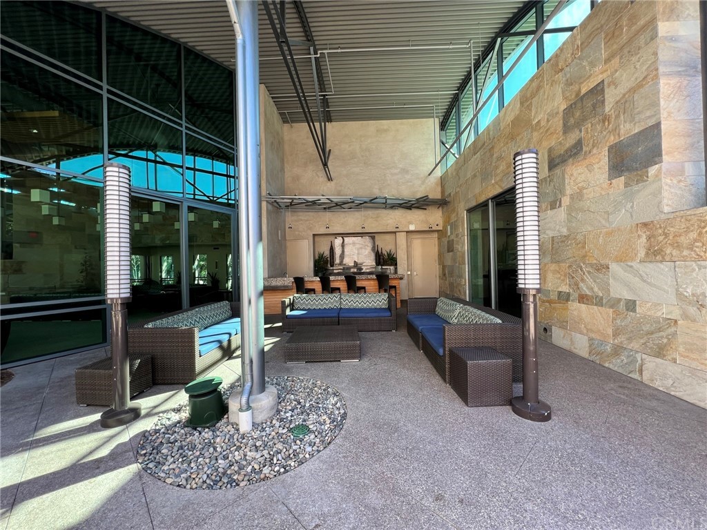 402 Rockefeller, Unit 212 Irvine, CA 92612 - Photo 26 of 27 a building outdoor space with patio furniture and potted plants
