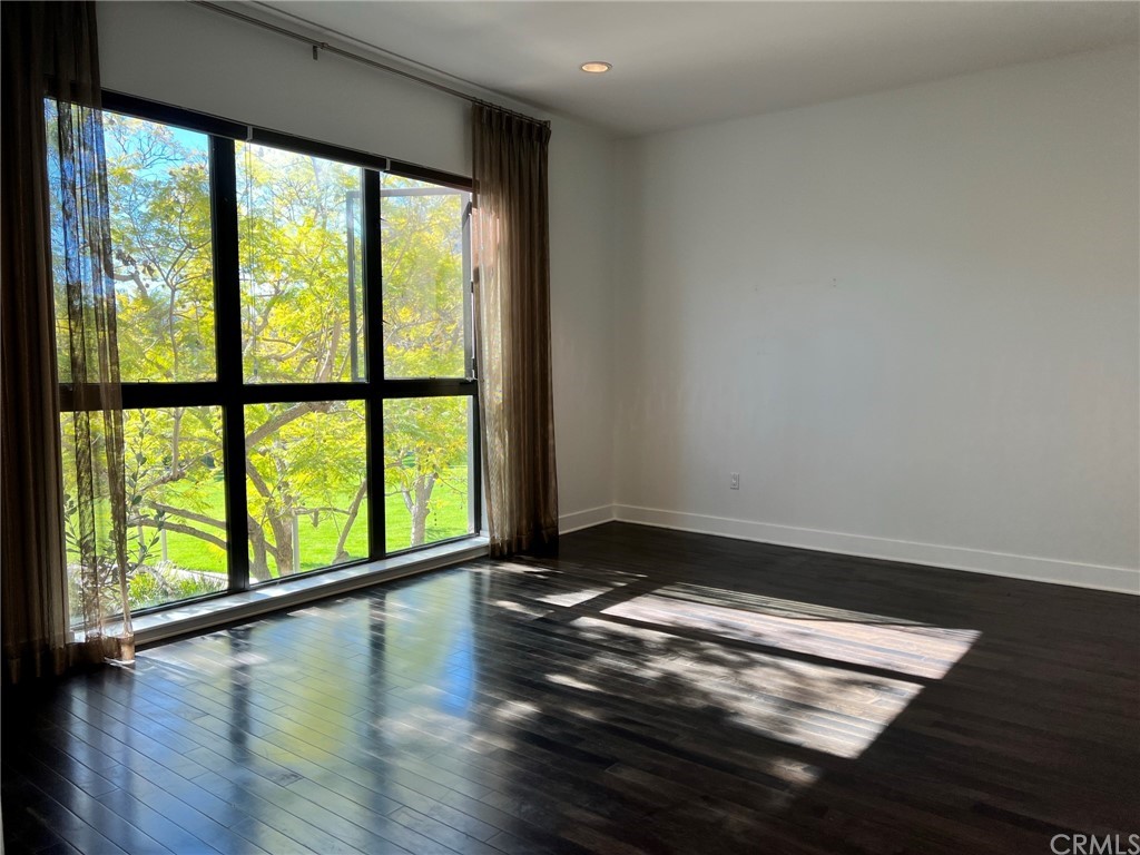 402 Rockefeller, Unit 212 Irvine, CA 92612 - Photo 7 of 27 a view of room with window and wooden floor