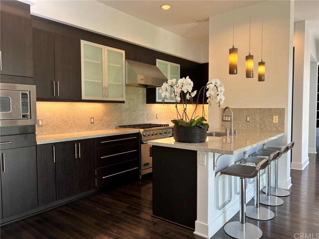 402 Rockefeller, Unit 212 Irvine, CA 92612 - Photo 8 of 27 a kitchen with stainless steel appliances granite countertop a stove and a refrigerator