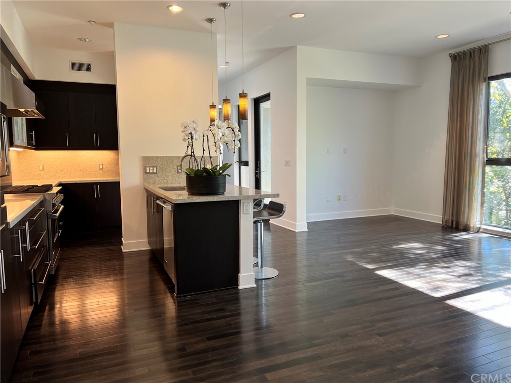 402 Rockefeller, Unit 212 Irvine, CA 92612 - Photo 9 of 27 an empty room with wooden floor and entrance