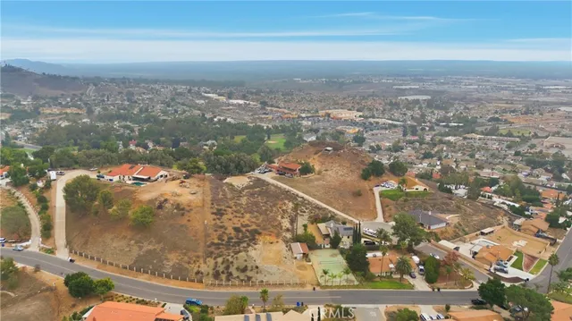 an aerial view of a house with a yard and lake