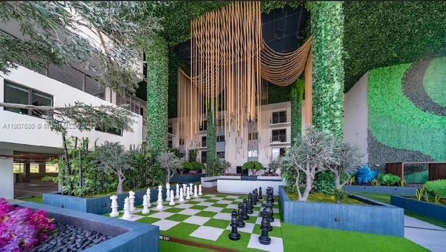 475 Southeast 1st Street, Unit 805A Pompano Beach, FL 33060 - Photo 19 of 19 a front view of a house with a garden