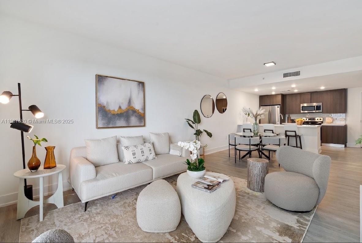 475 Southeast 1st Street, Unit 805A Pompano Beach, FL 33060 - Photo 3 of 19 a living room with furniture and kitchen view
