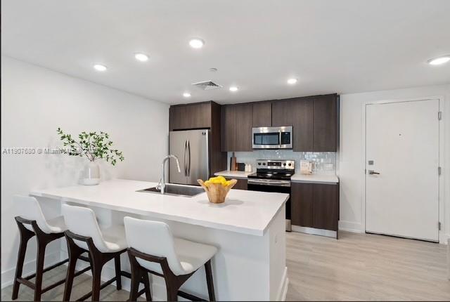 475 Southeast 1st Street, Unit 805A Pompano Beach, FL 33060 - Photo 4 of 19 a kitchen with a table and chairs in it