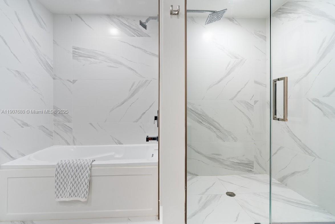 475 Southeast 1st Street, Unit 805A Pompano Beach, FL 33060 - Photo 10 of 19 a bathroom with a bathtub and shower