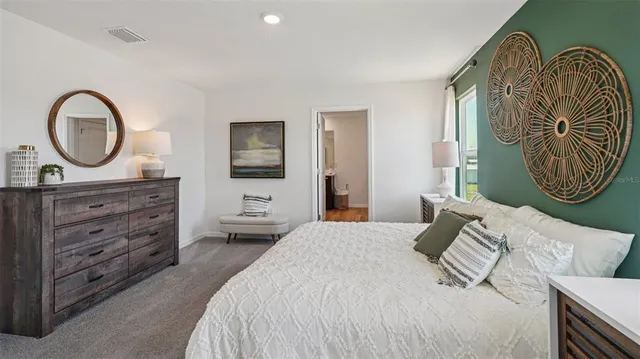 a bedroom with a large bed and a window