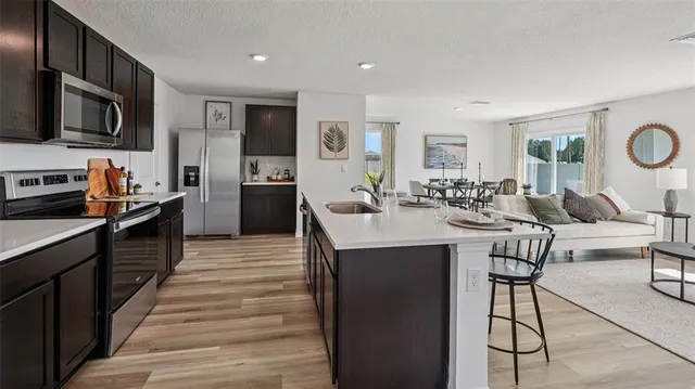 a kitchen with stainless steel appliances kitchen island granite countertop a sink and cabinets