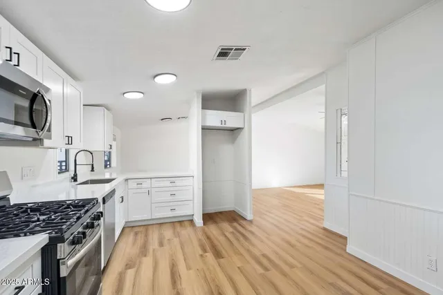 a kitchen with granite countertop a stove and a sink
