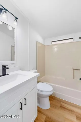 a bathroom with a sink a toilet and a large mirror