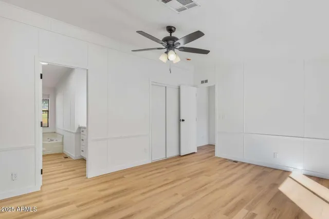 a view of empty room with wooden floor