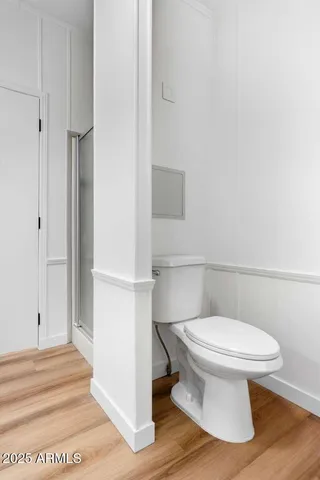 a white toilet sitting next to a bathroom sink